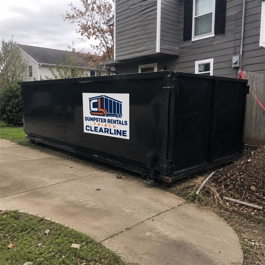 Loaded Dumpster Rentals Frisco Clearline roll-off container on a residential driveway