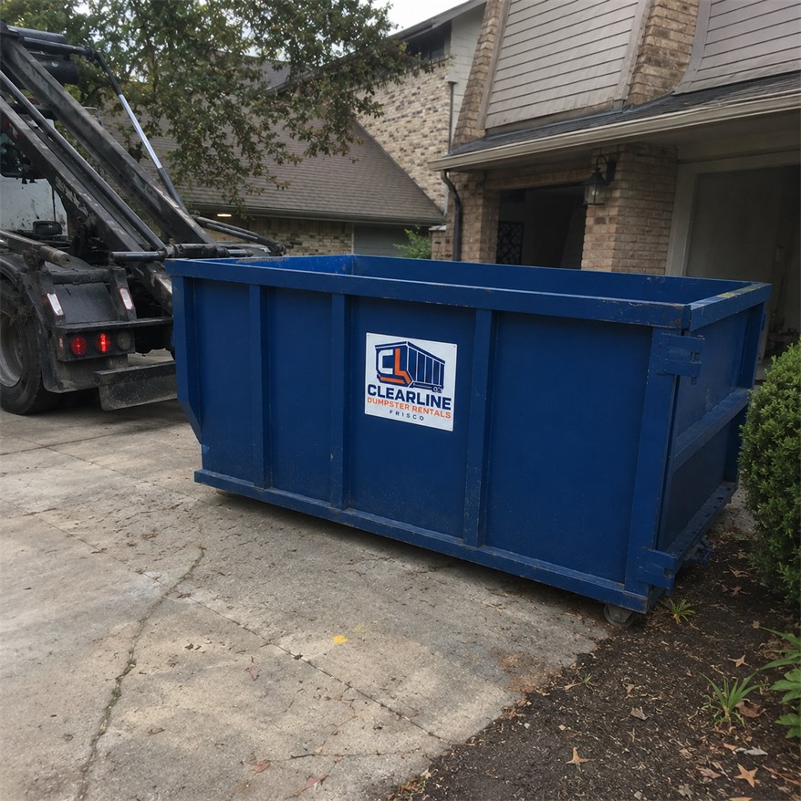 Blue Dumpster Rentals Frisco Clearline roll-off container placed beside a home